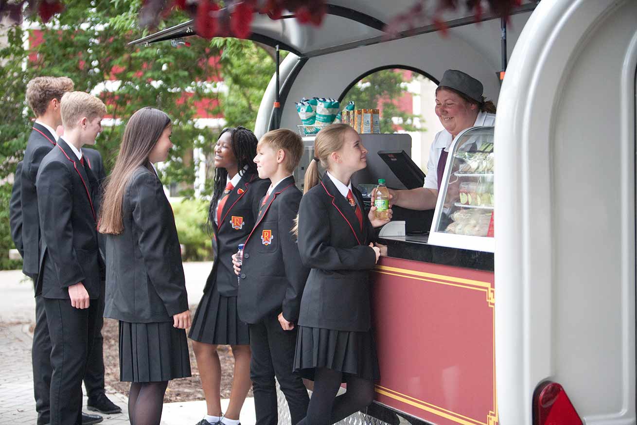 Students at a school catering trailer
