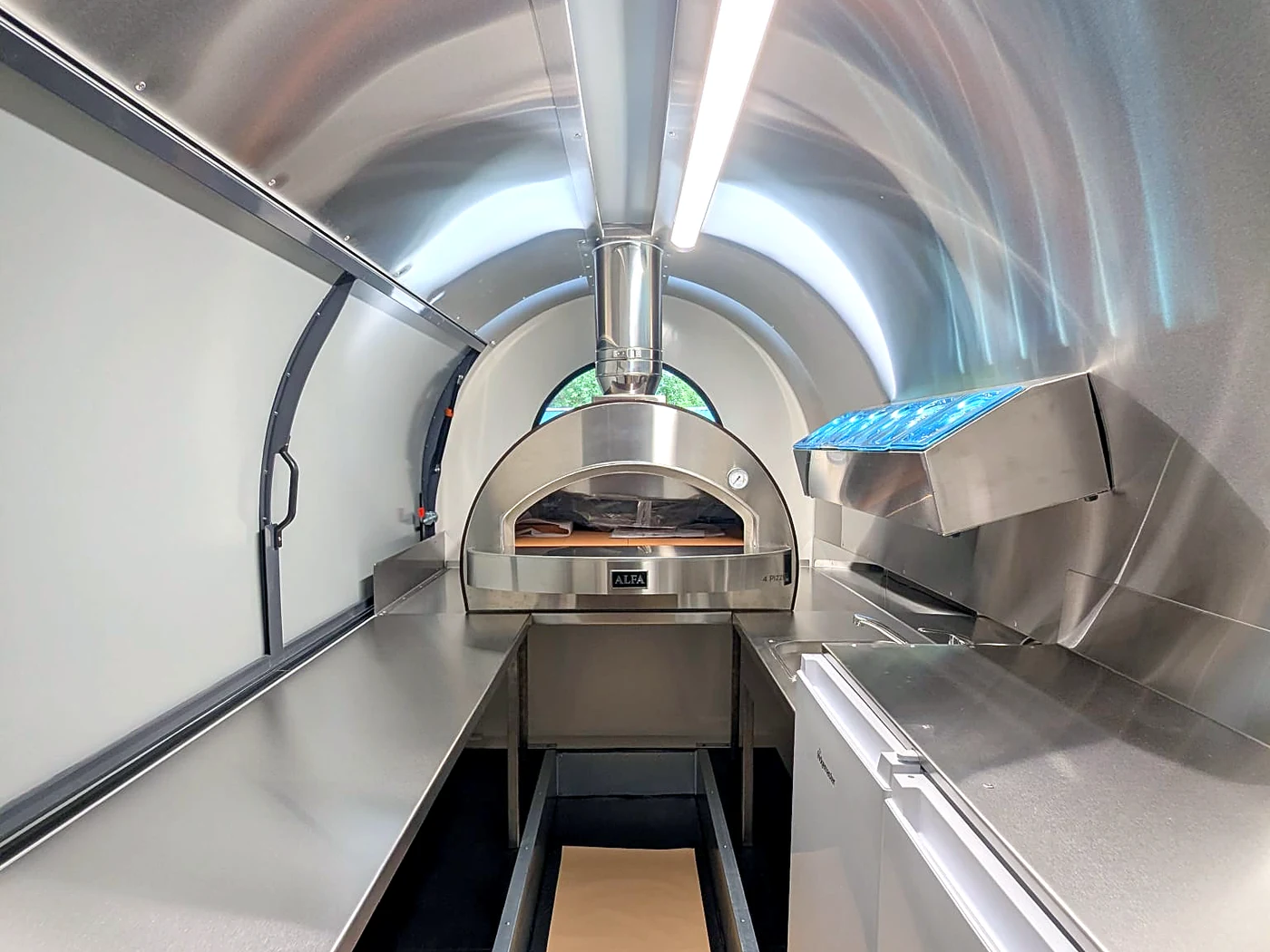 Inside a pizza Caterpod: stainless kitchen with Alfa pizza oven