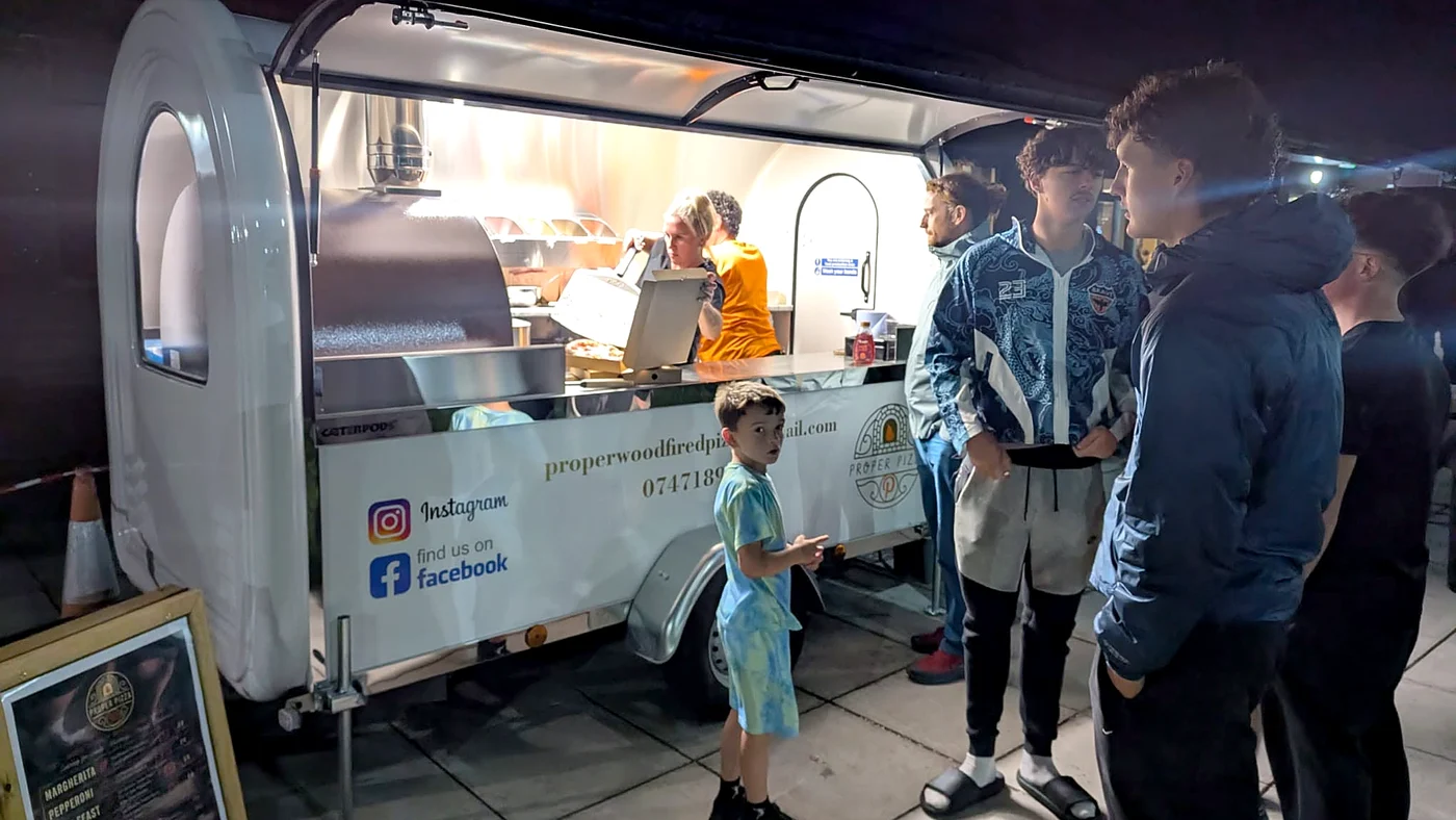 Customers queuing at a Caterpod at a night event