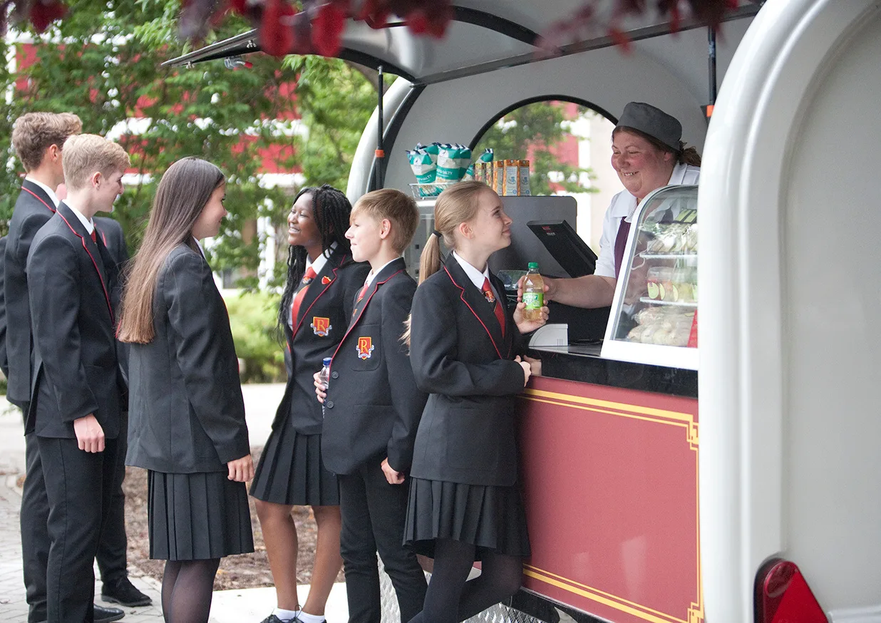 Pupils being served from a Caterpod at school