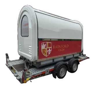 Rainford High Caterpod on its delivery trailer